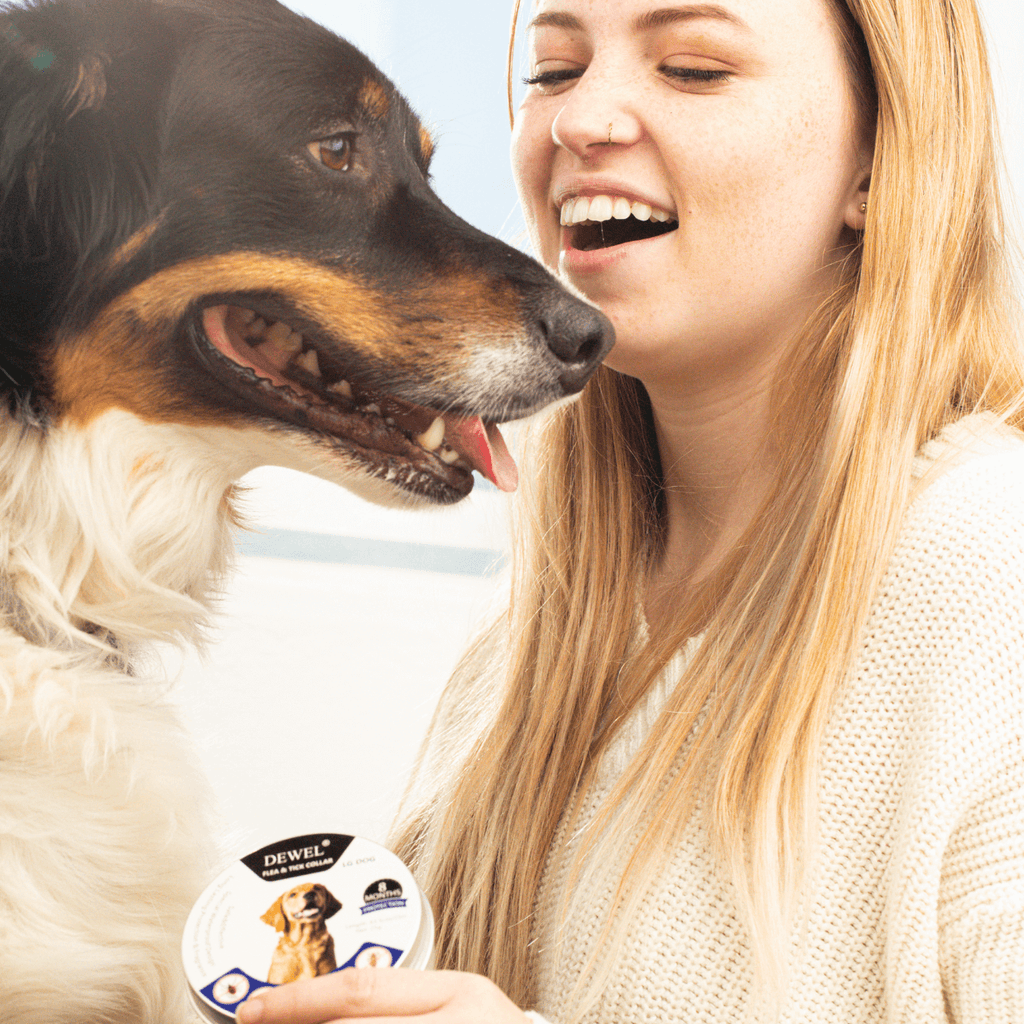 Woman with a dog happily holding a Dewel Collar Tin